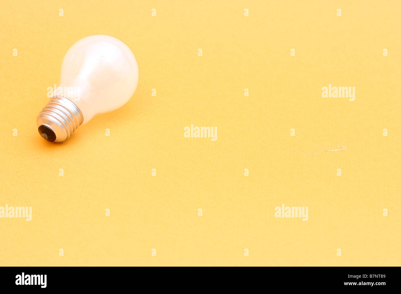 Background with lit lightbulb on yellow Stock Photo - Alamy