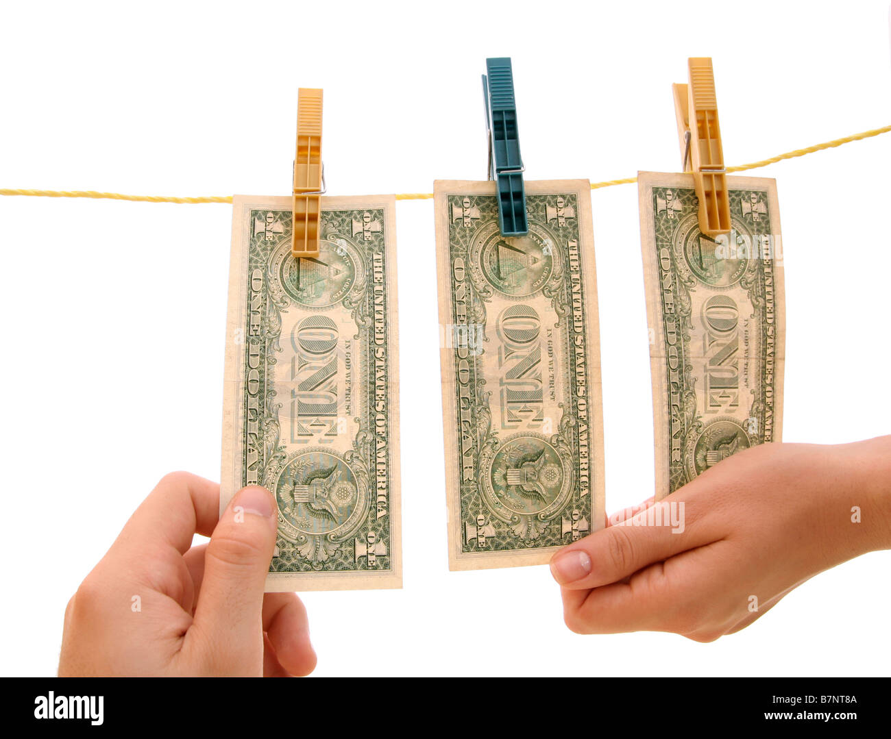 dollars on a clothesline; isolated on white background Stock Photo