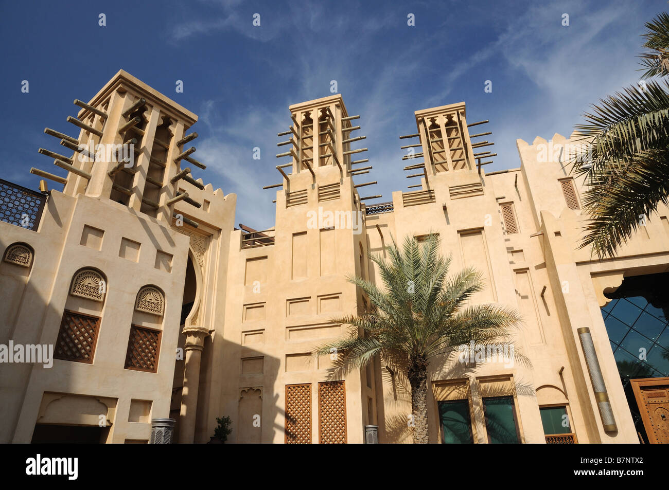 Buildings with Traditional Arabic Wind Towers in Dubai, United Arab Emirates Stock Photo
