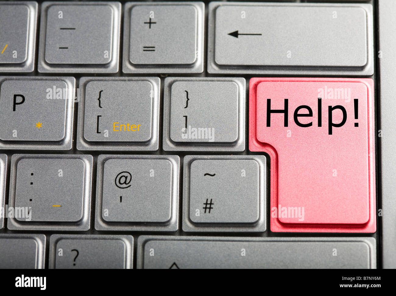 Close up of a section of a special silver laptop keyboard with a red Help key for customer support Stock Photo