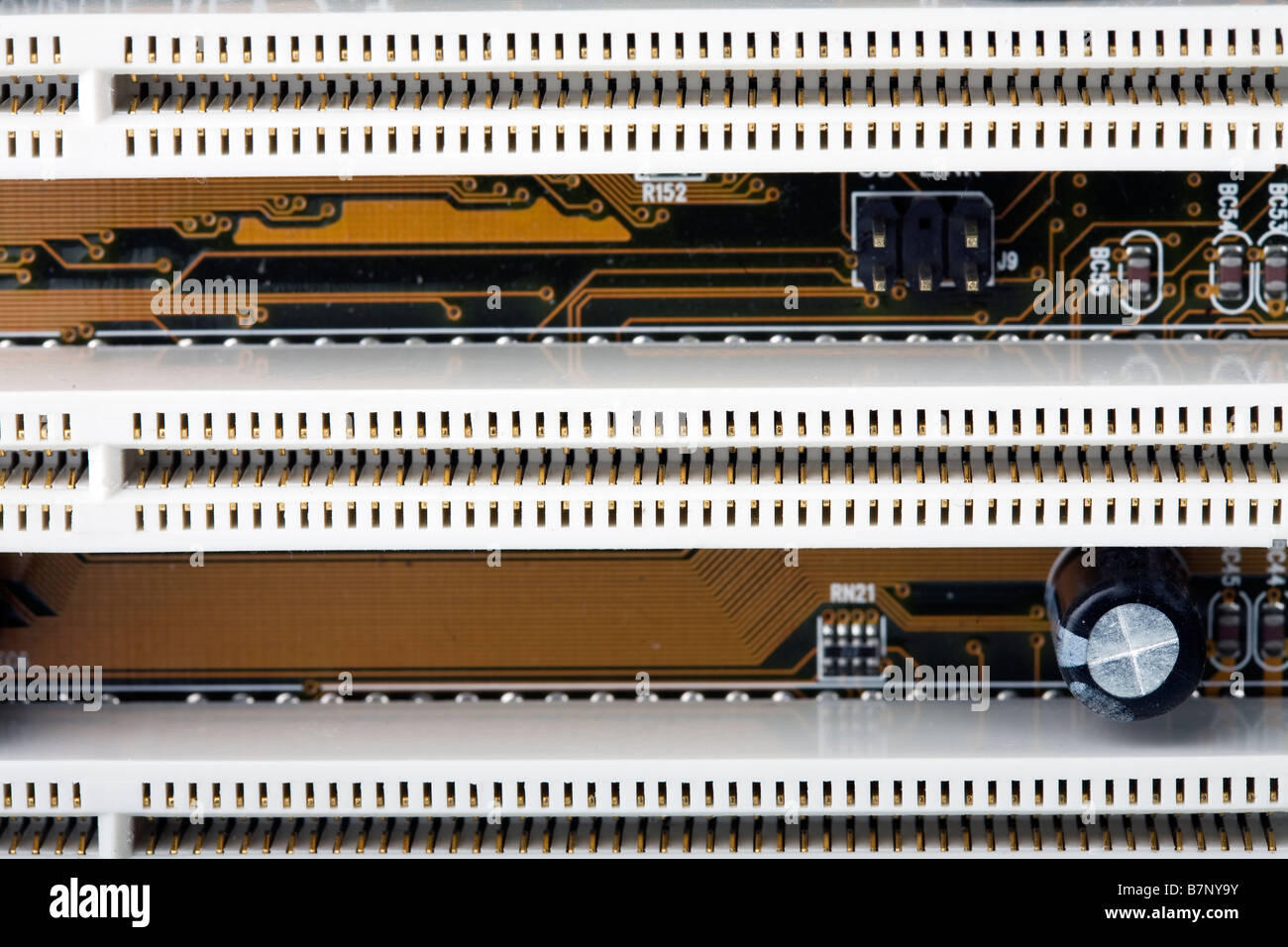 Close up of section of a computer motherboard showing rows of PCI slots