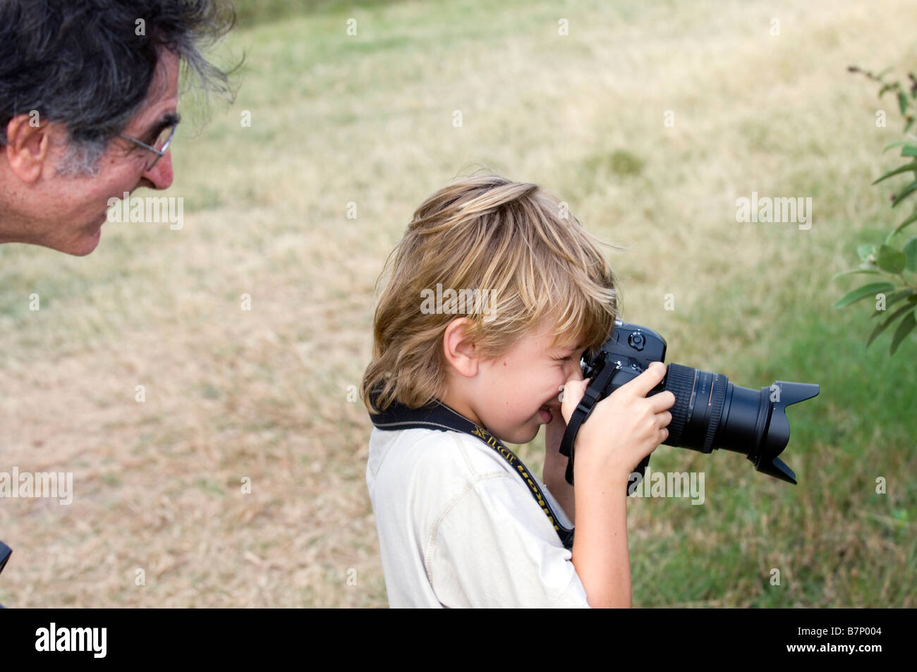 Young boy receiving photography lessons Stock Photo