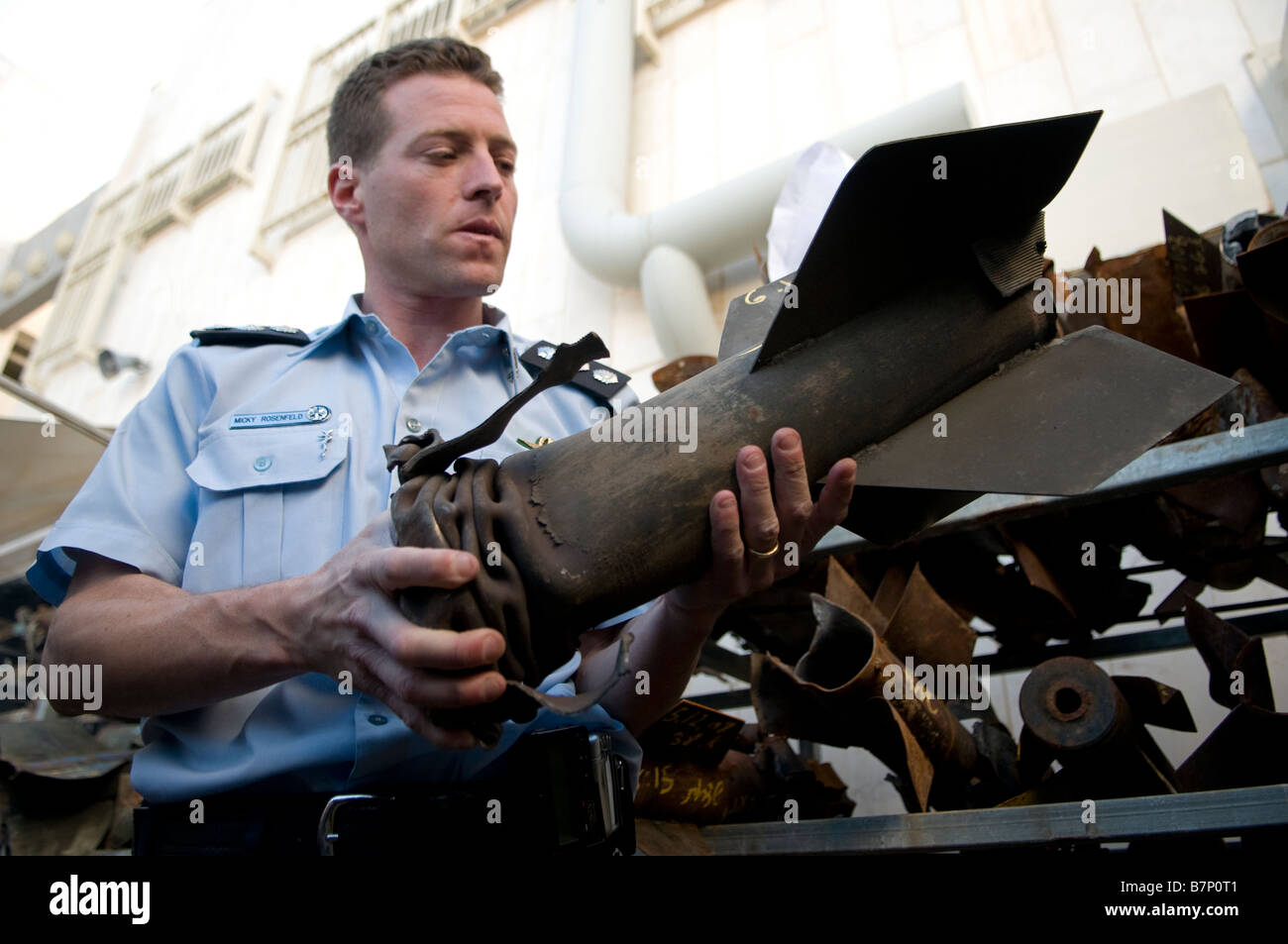 Superintendent Micky Rosenfeld, Israel Police Spokesperson holds remnant of a Qassam rocket that was fired from Gaza in the town of Sderot Israel Stock Photo