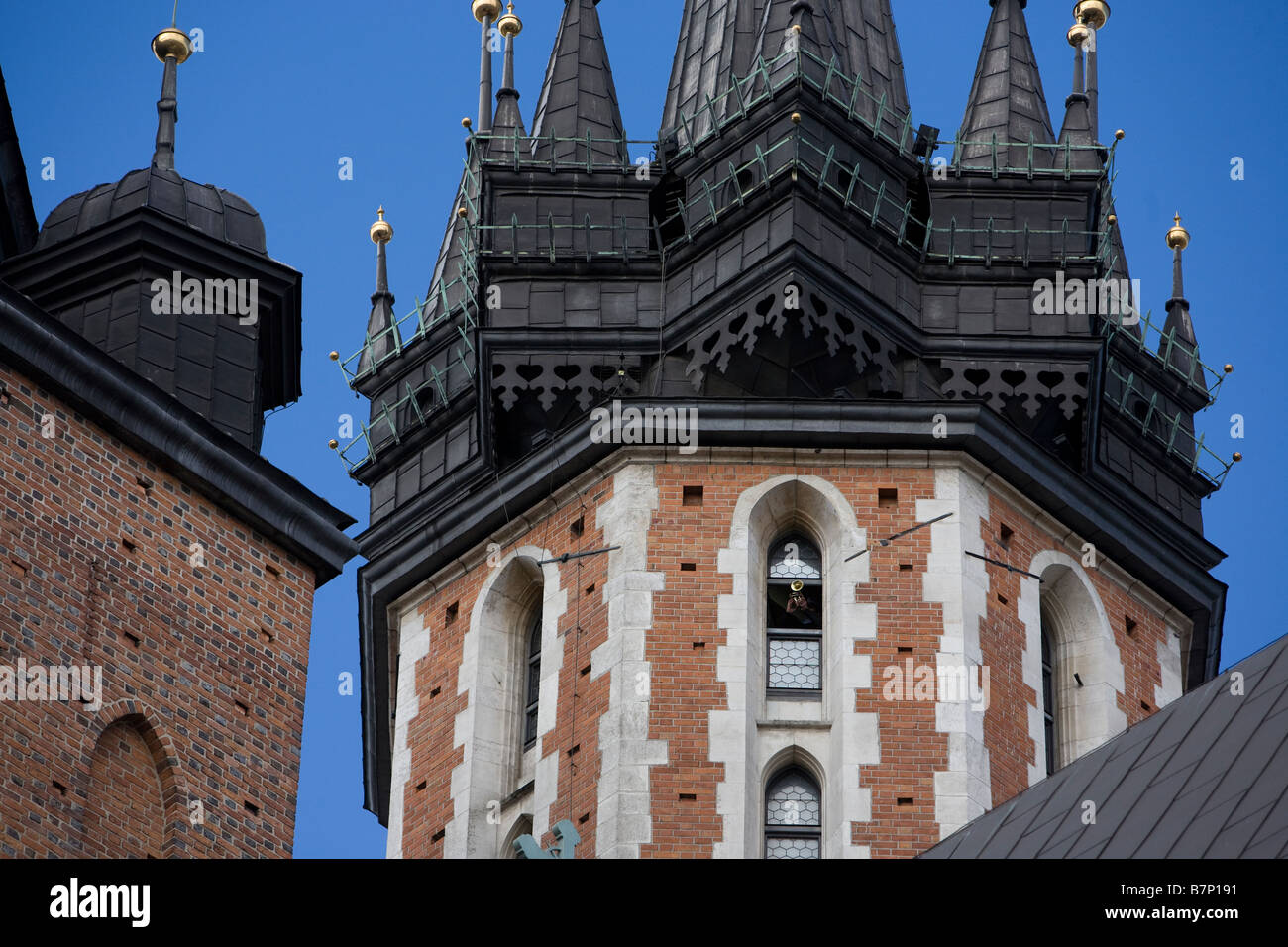 Bugler plays from window of St Marys Church, Krakow, Poland. Stock Photo