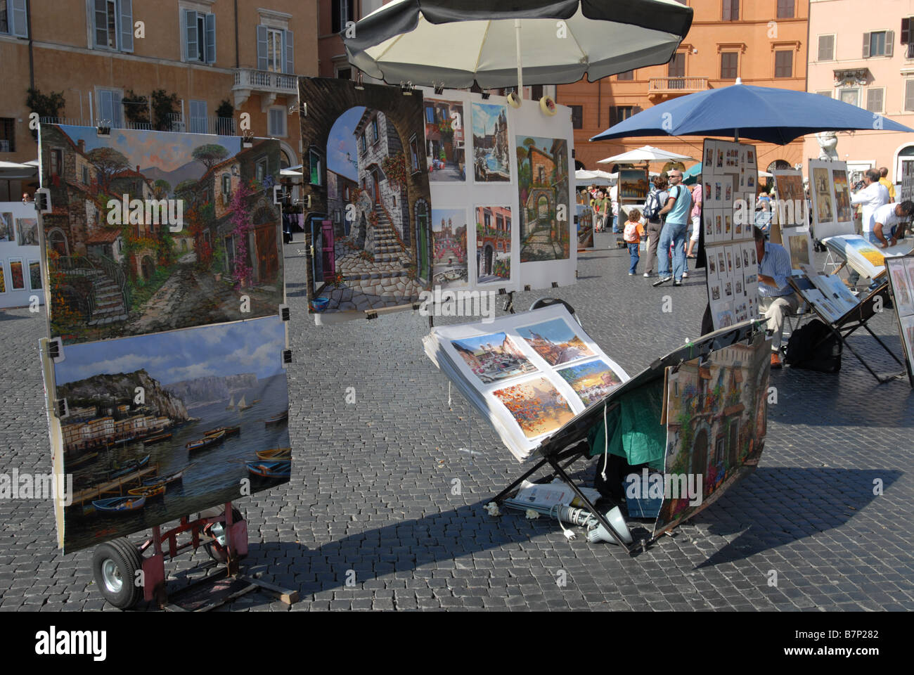 A display of cheap tourist art in Piazza Navona Rome Most of this sort of mass produced paintings are done in China Stock Photo