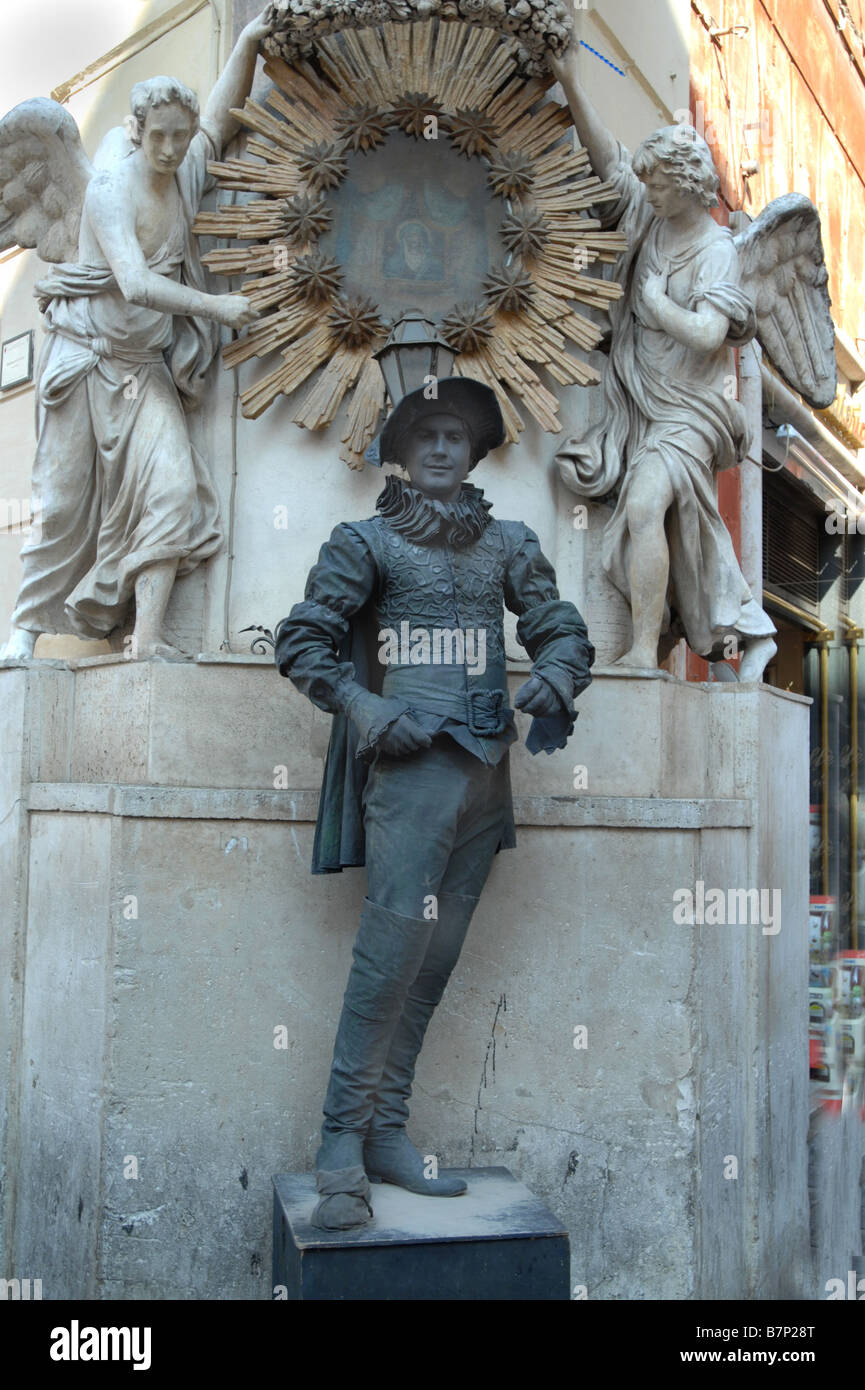 Street performer dressed as a living bronze sculpture on the streets of Rome Italy Stock Photo