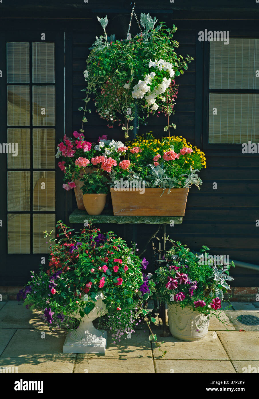 Assorted planted containers on a garden terrace Stock Photo
