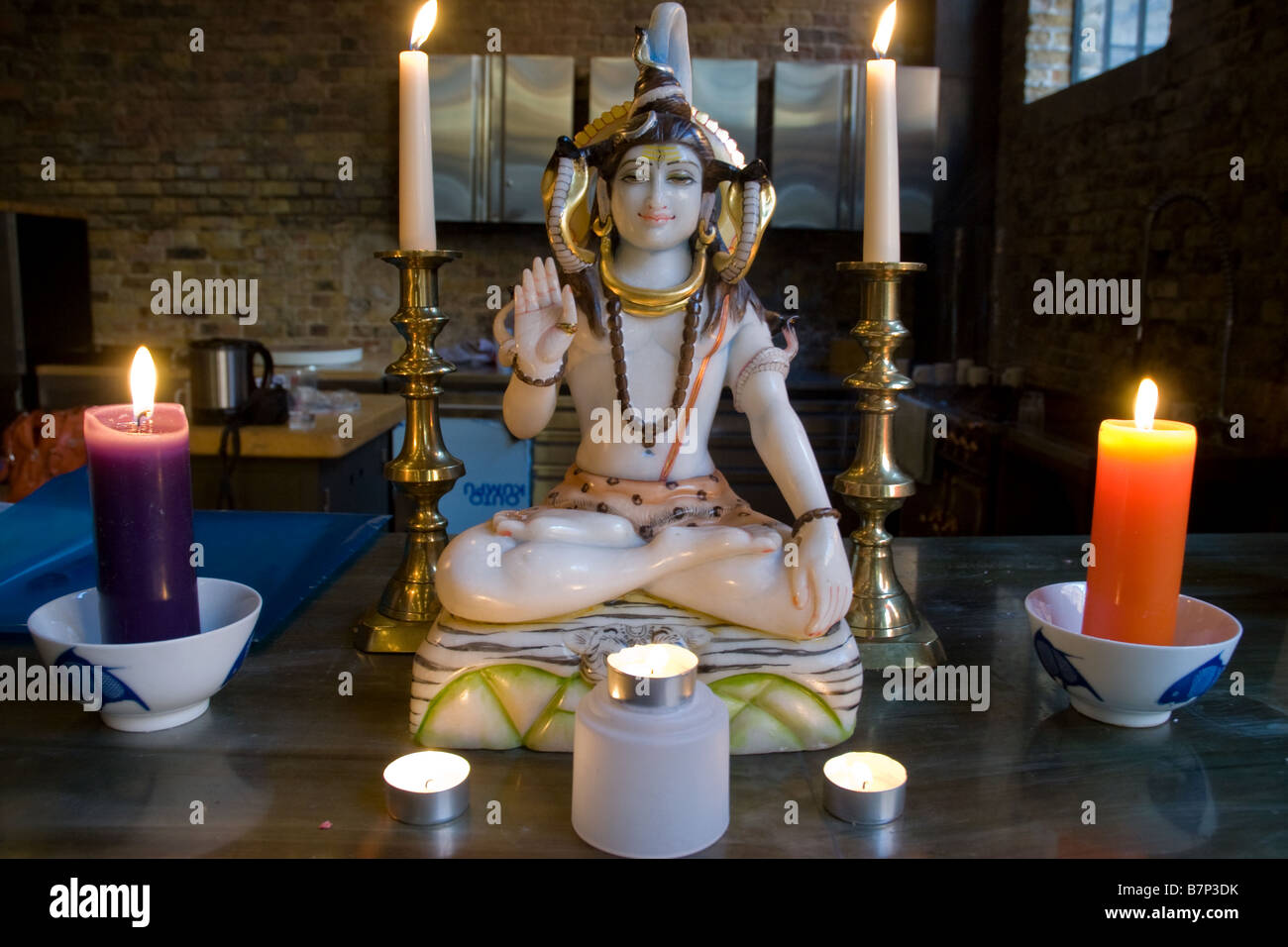 Ganesh Hindu god statue with candles Stock Photo - Alamy