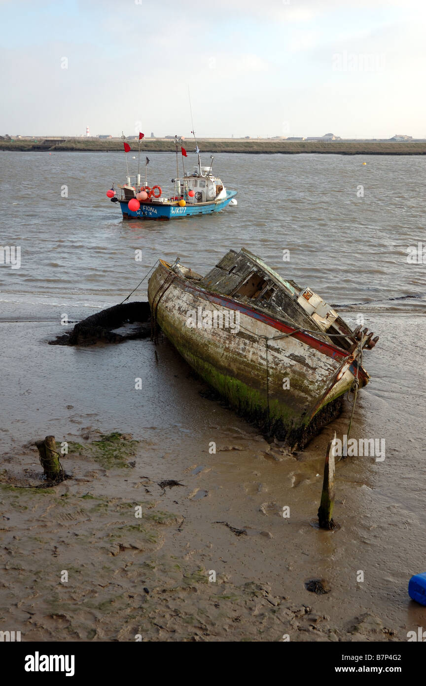 Derelict boat on the edge of the River Ore at Orford, Suffolk, UK Stock Photo