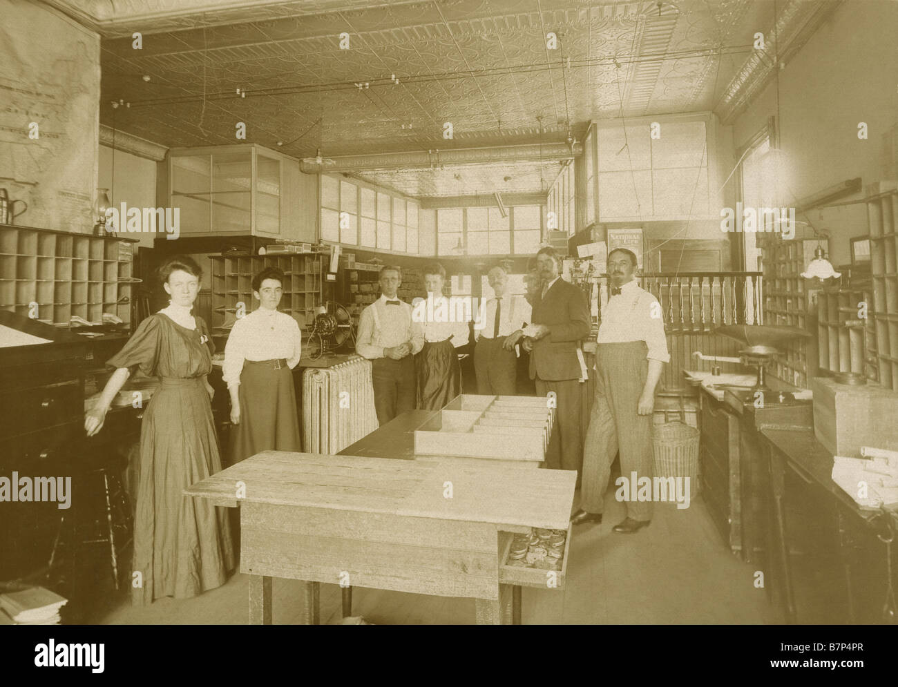 Circa 1890s photograph of an old mailroom or sorting room with the managers and employees. Stock Photo