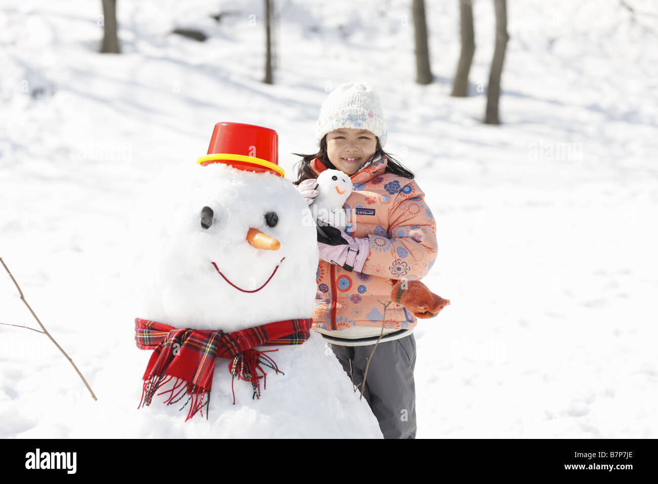 A girl and snowmen Stock Photo - Alamy