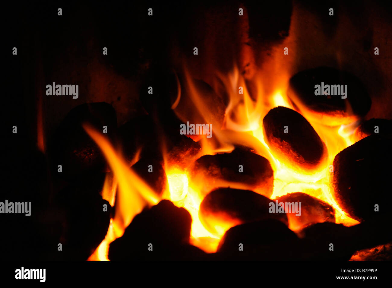 Smokeless coal burning in a grate of a domestic home in a smokeless zone during cold weather. Stock Photo