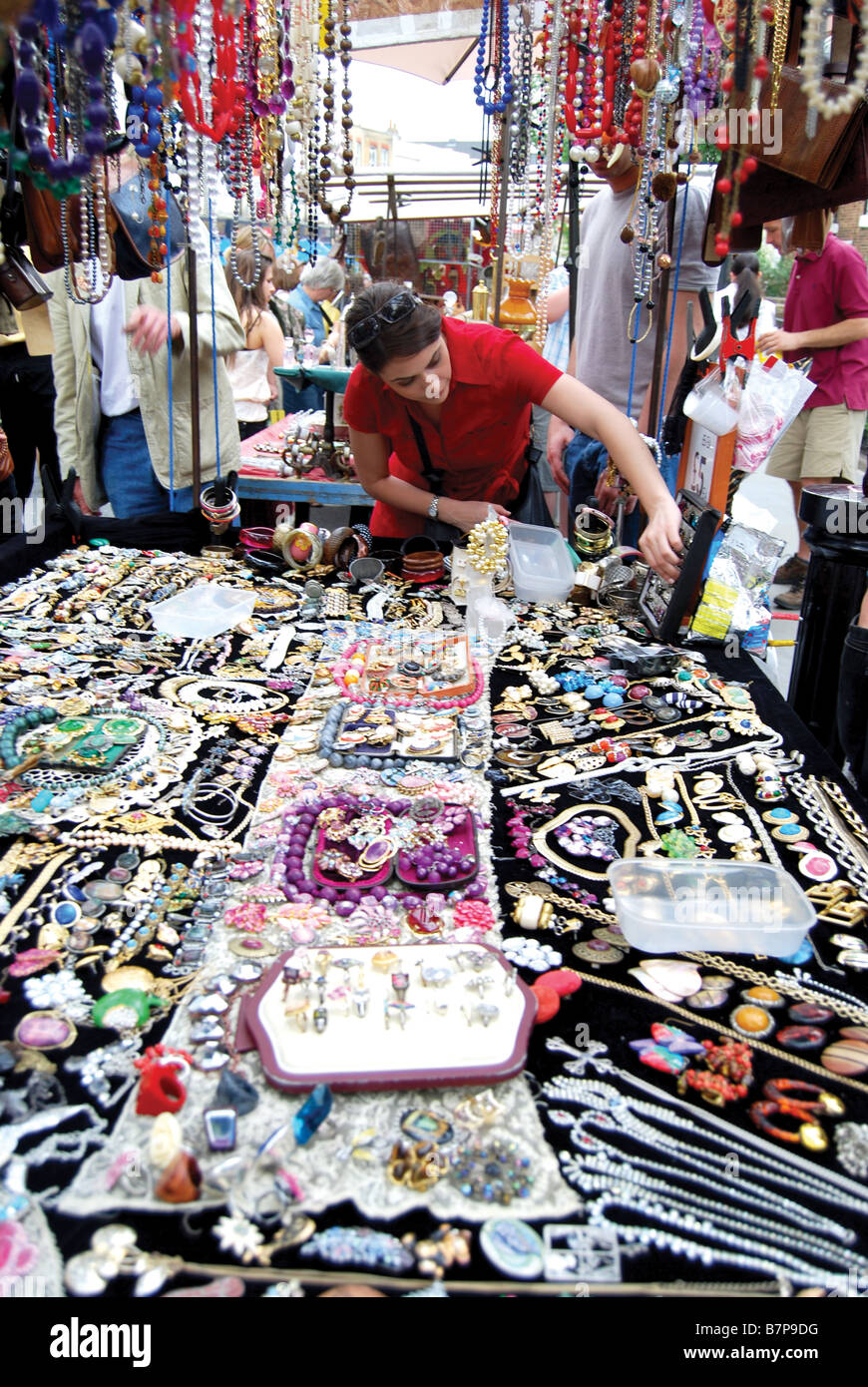 Woman on Portobello Market, London browsing through jewellery Stock