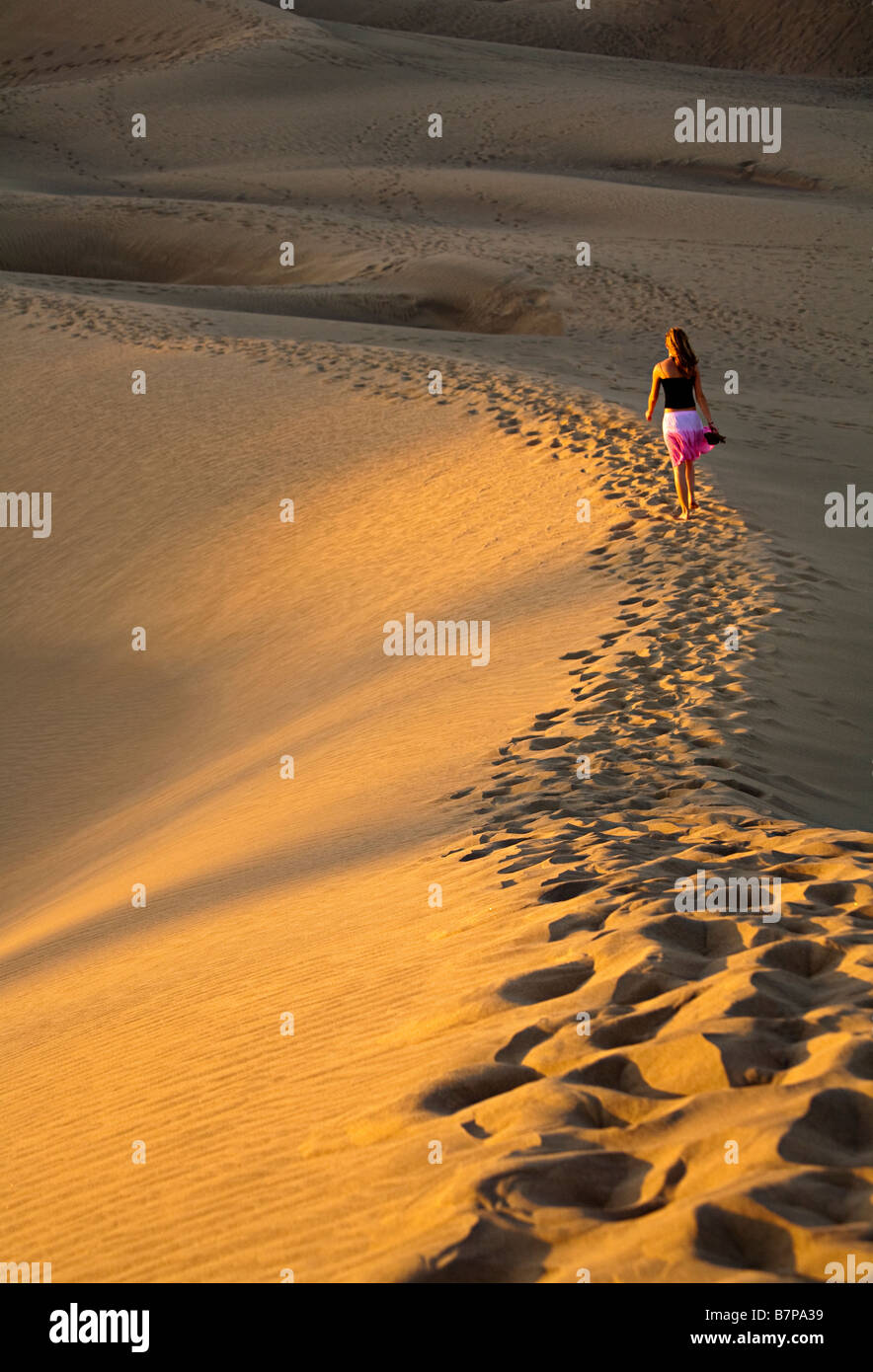 Woman walking in dunes Maspalomas Gran Canaria Spain Stock Photo