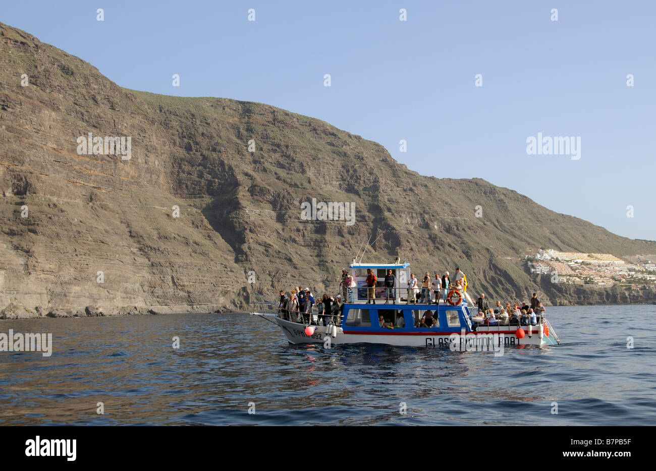 Tourists on a glass bottom boat excursion along the Los Gigantes Cliffs