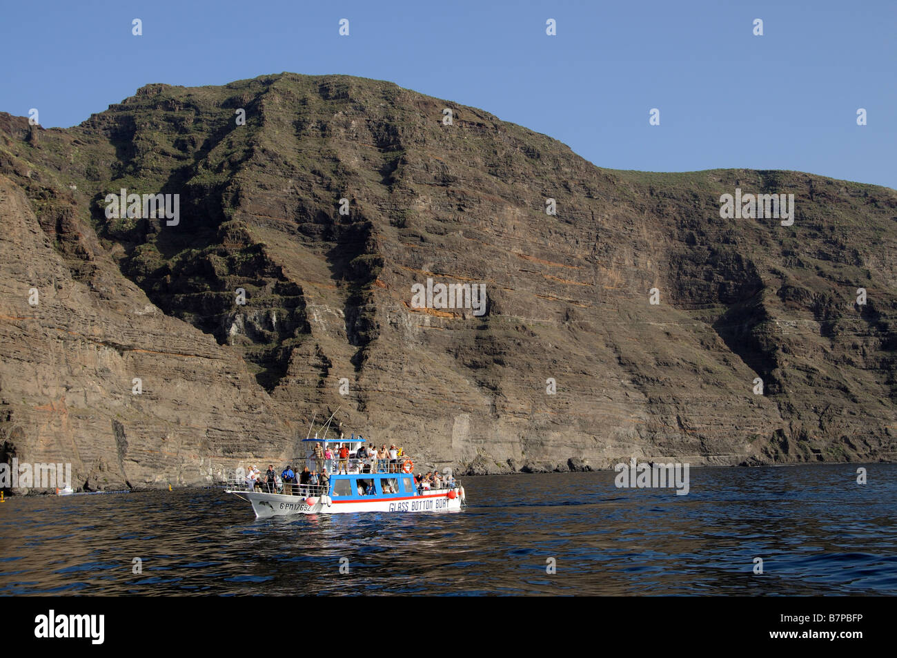 Tourists on a glass bottom boat excursion along the Los Gigantes Cliffs