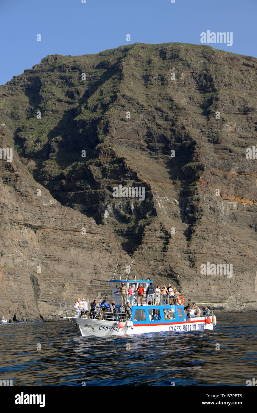 Tourists on a glass bottom boat excursion along the Los Gigantes Cliffs coast of southern Tenerife Canary Islands Stock Photo