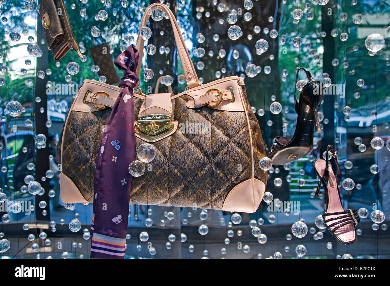 Louis Vuitton bag show window display Singapore Orchard road modern fashion luxury shopping mall shop shops stores Stock Photo -