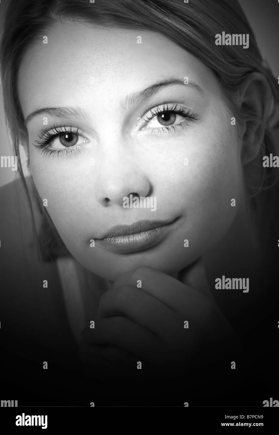 Young Woman's face in spotlight Stock Photo Alamy
