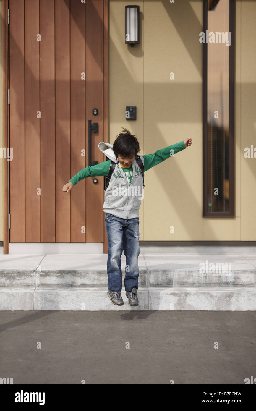 A boy going out of front door Stock Photo