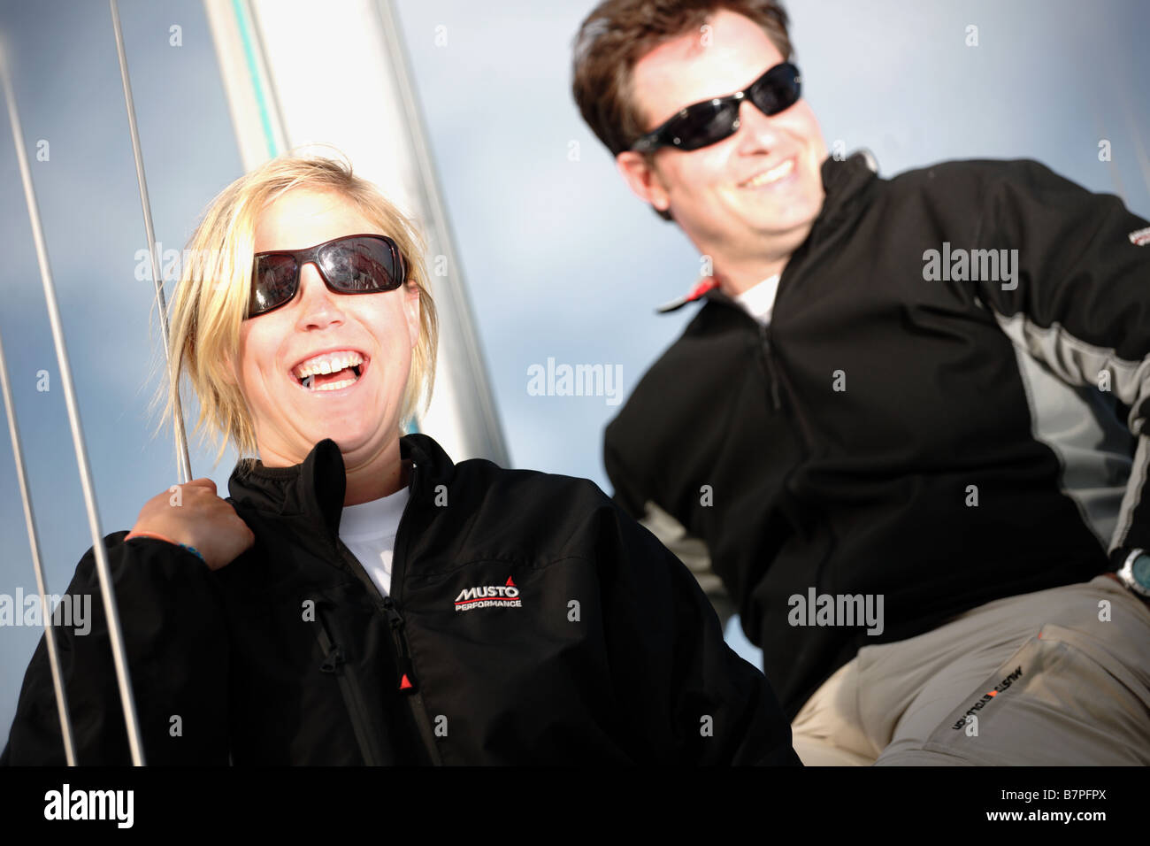 2 people,white Europeans, one male one female sailing a yacht. Stock Photo