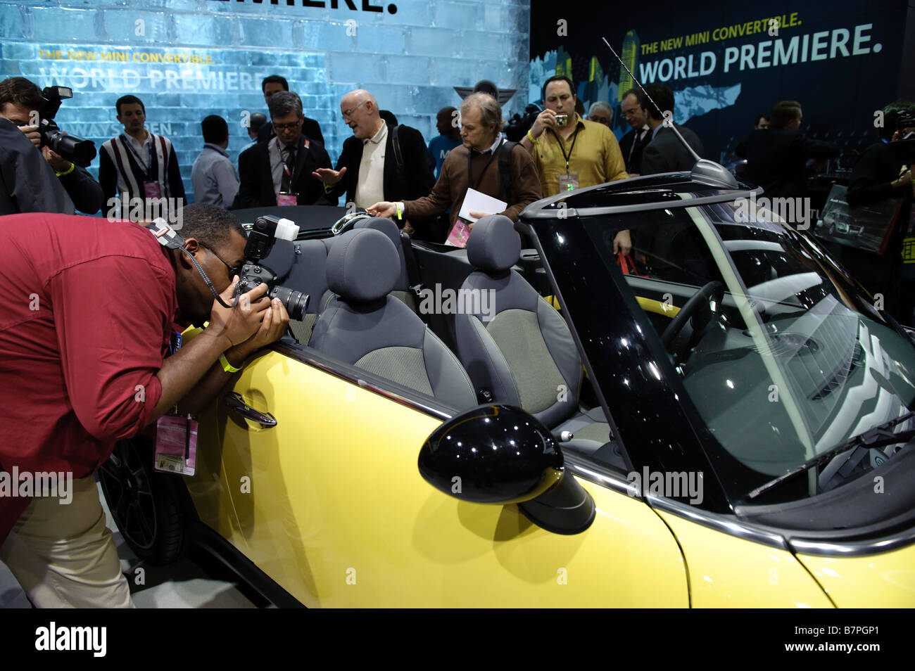 Journalists look at the new MINI Cooper S Convertible at the 2009 North American International Auto Show in Detroit Michigan USA Stock Photo