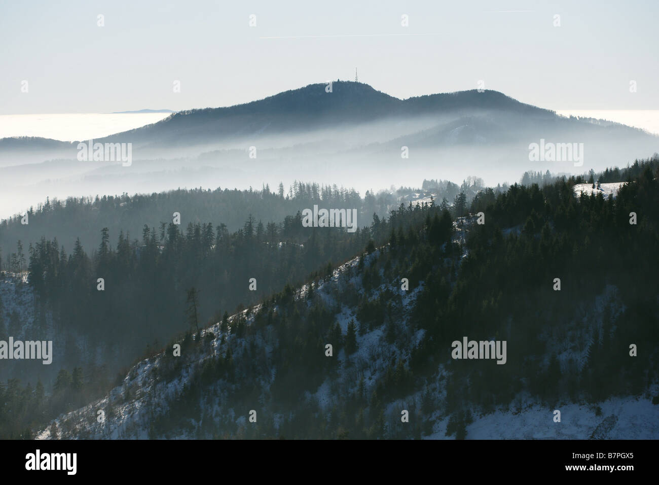 Mt. Sitno above Banska Stiavnica town, Slovakia, from Paradajs hill mountain in winter haze valley inversion blue sky Stock Photo