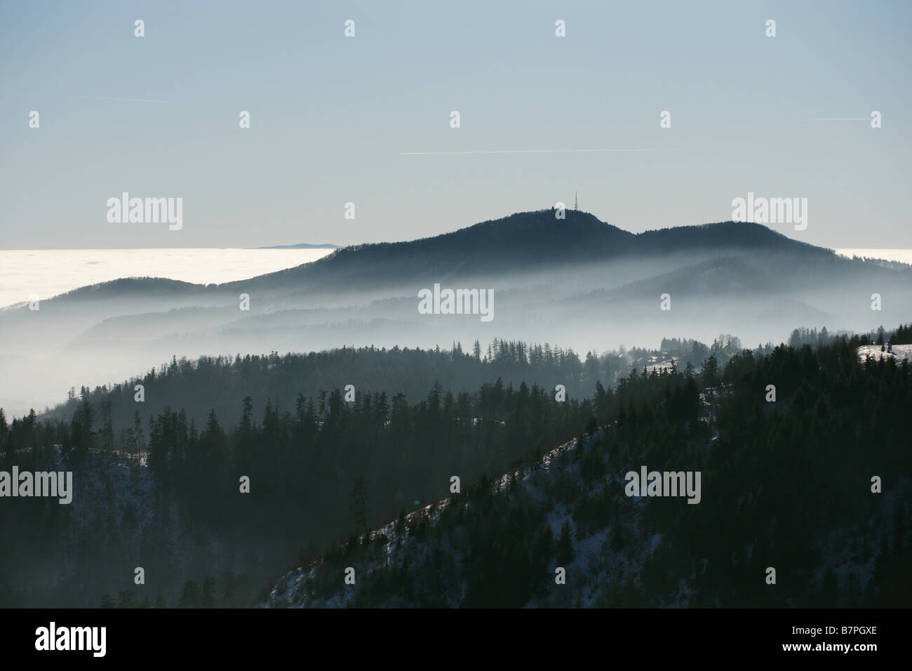 Mt. Sitno above Banska Stiavnica town, Slovakia, from Paradajs hill mountain in winter haze valley inversion blue sky Stock Photo