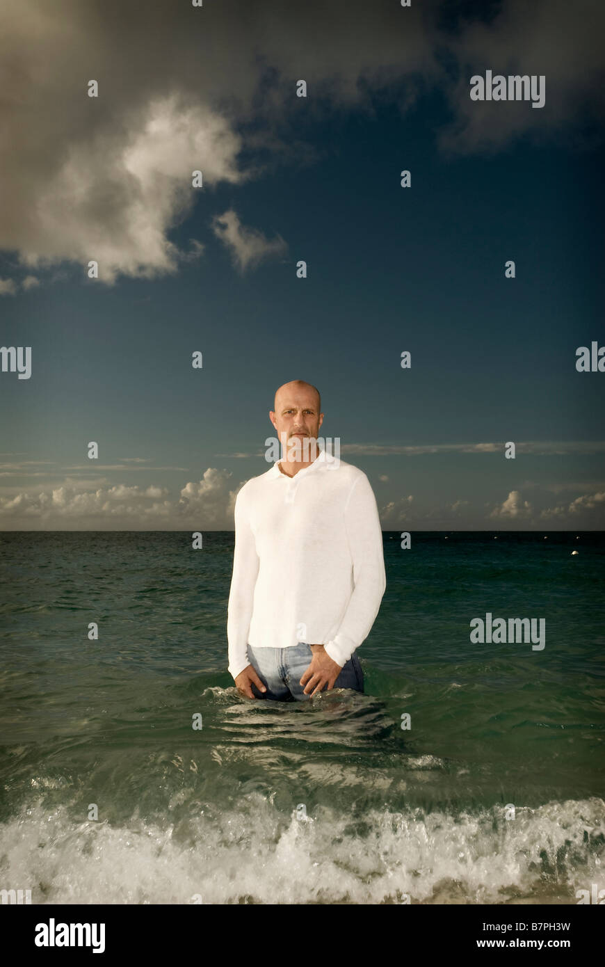 man standing in ocean posing for portrait Stock Photo