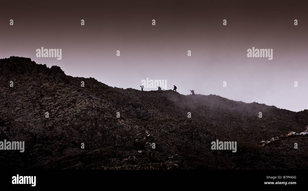 Climbers making their way along summit of Crib Goch Snowdonia Wales Stock Photo