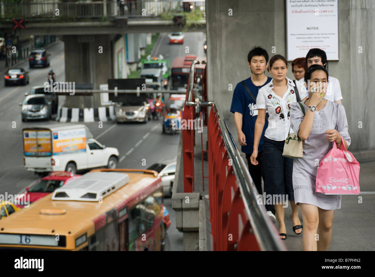 Woman trying to avoid traffic pollution with handkerchief Pathumwan district in central Bangkok Thailand Stock Photo