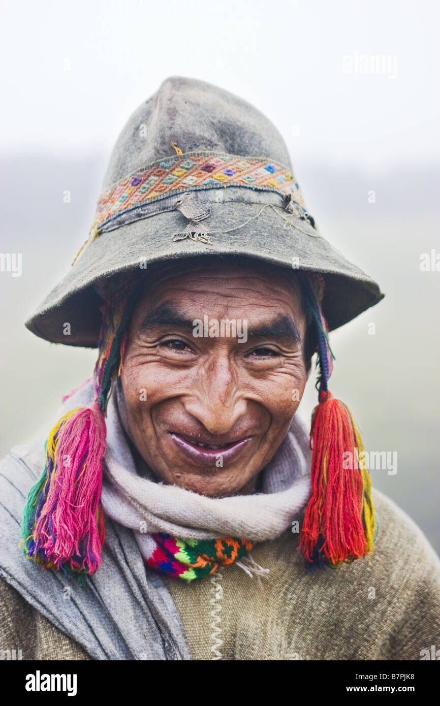 A Q'eros elder stands in the mist wearing traditional alpaca wool clothing and embroidery. Stock Photo