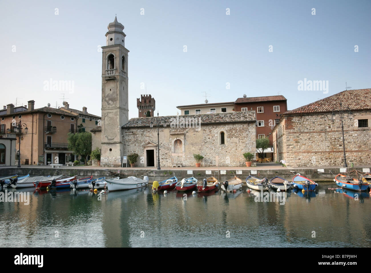 Early morning by the harbour in Lazise with the San Nicolò Church Stock Photo