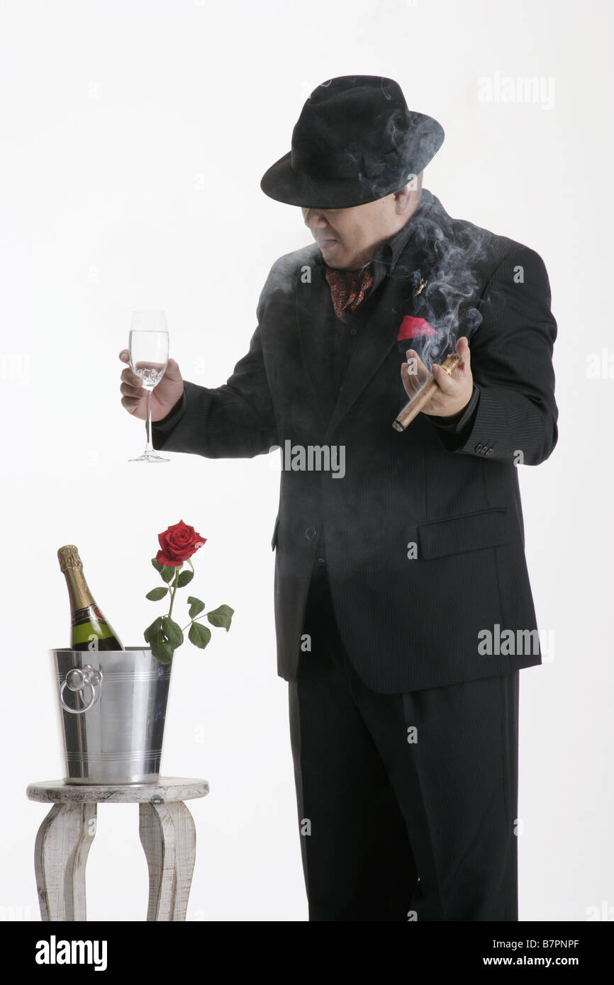 A man in suit holding a glass Stock Photo