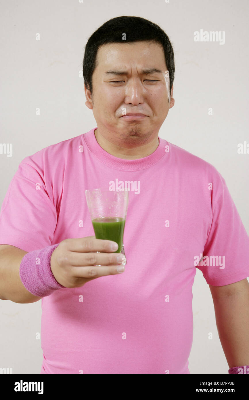 A man drinking green juice Stock Photo Alamy