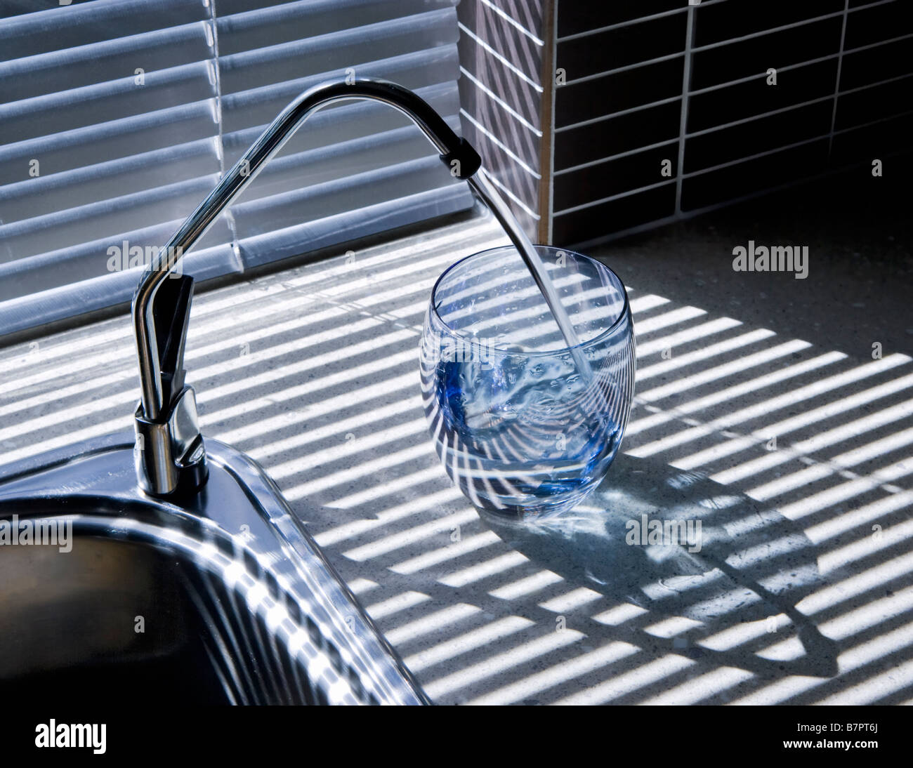 Filtered Water Pouring Into A Glass From A Under Sink Water