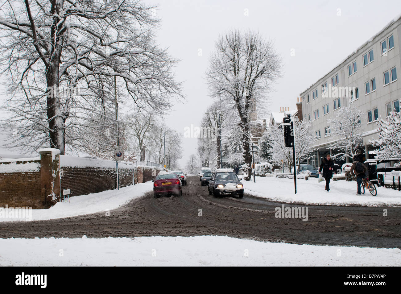 Cars driving on the road covered with slush Kingston Surrey UK Stock Photo Alamy