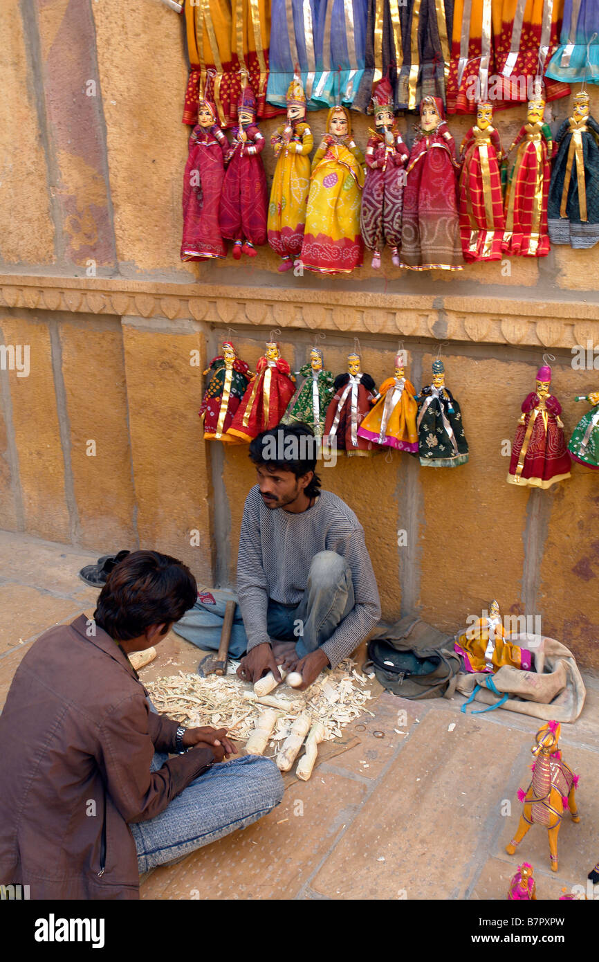 indian boys carving traditional puppets for sale in the backstreets of the old city of jaisalmer Stock Photo