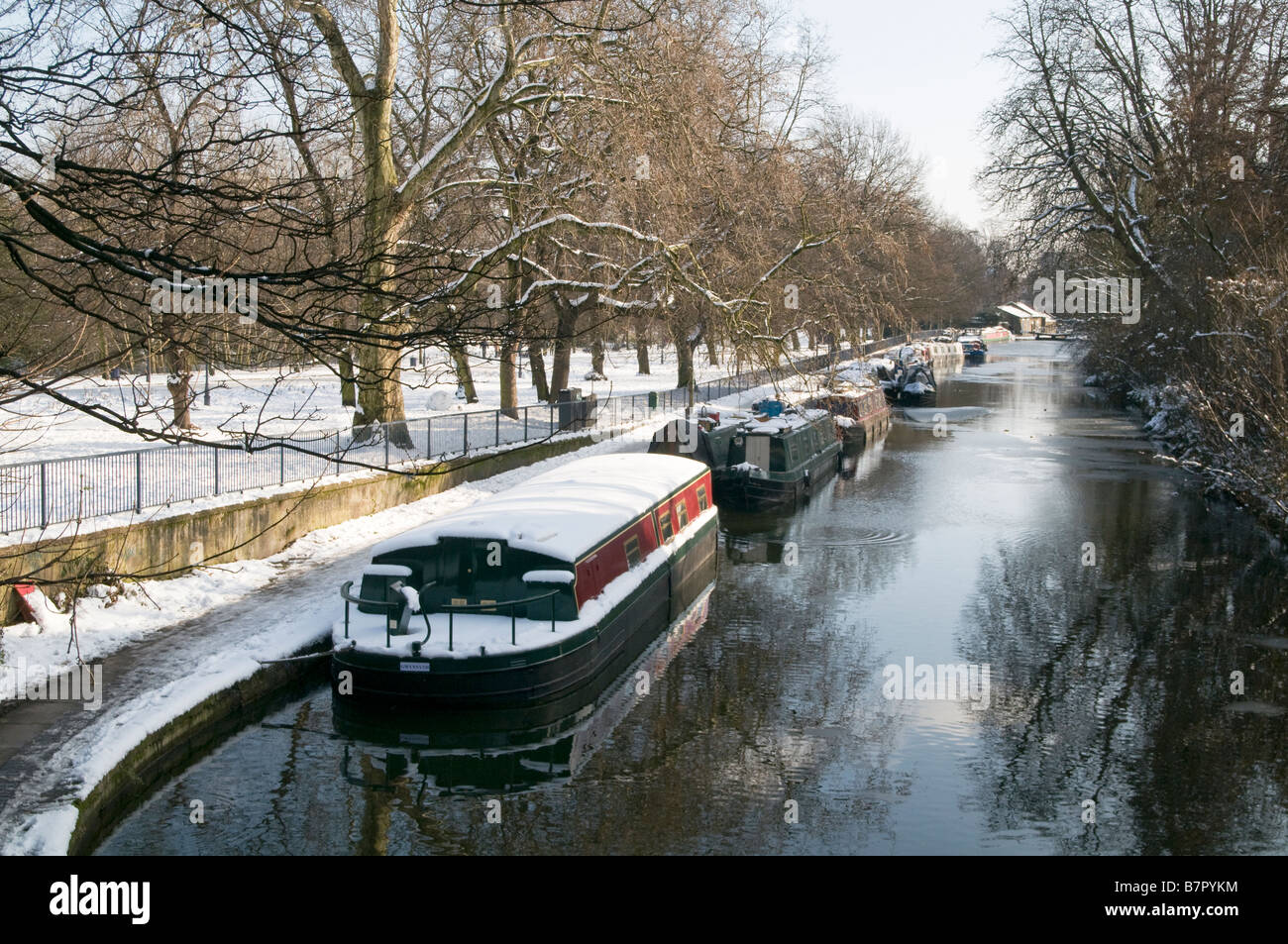 UK.Barges covered in snow by the Regent's Canal in Victoria Park, London Photo Julio Etchart Stock Photo