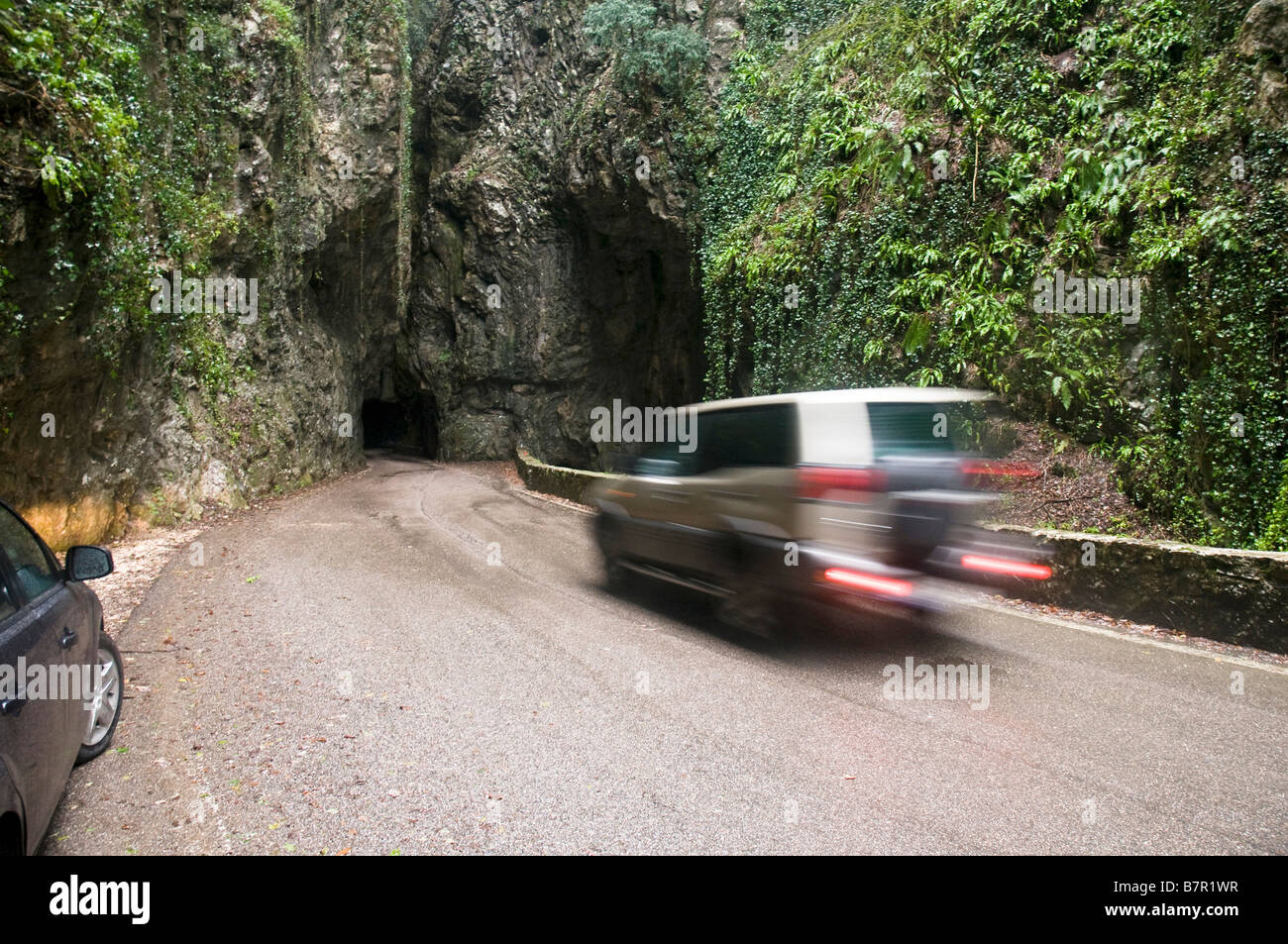Italy The Dolomites A car speeding into a narrow tunnel in the mountain Stock Photo