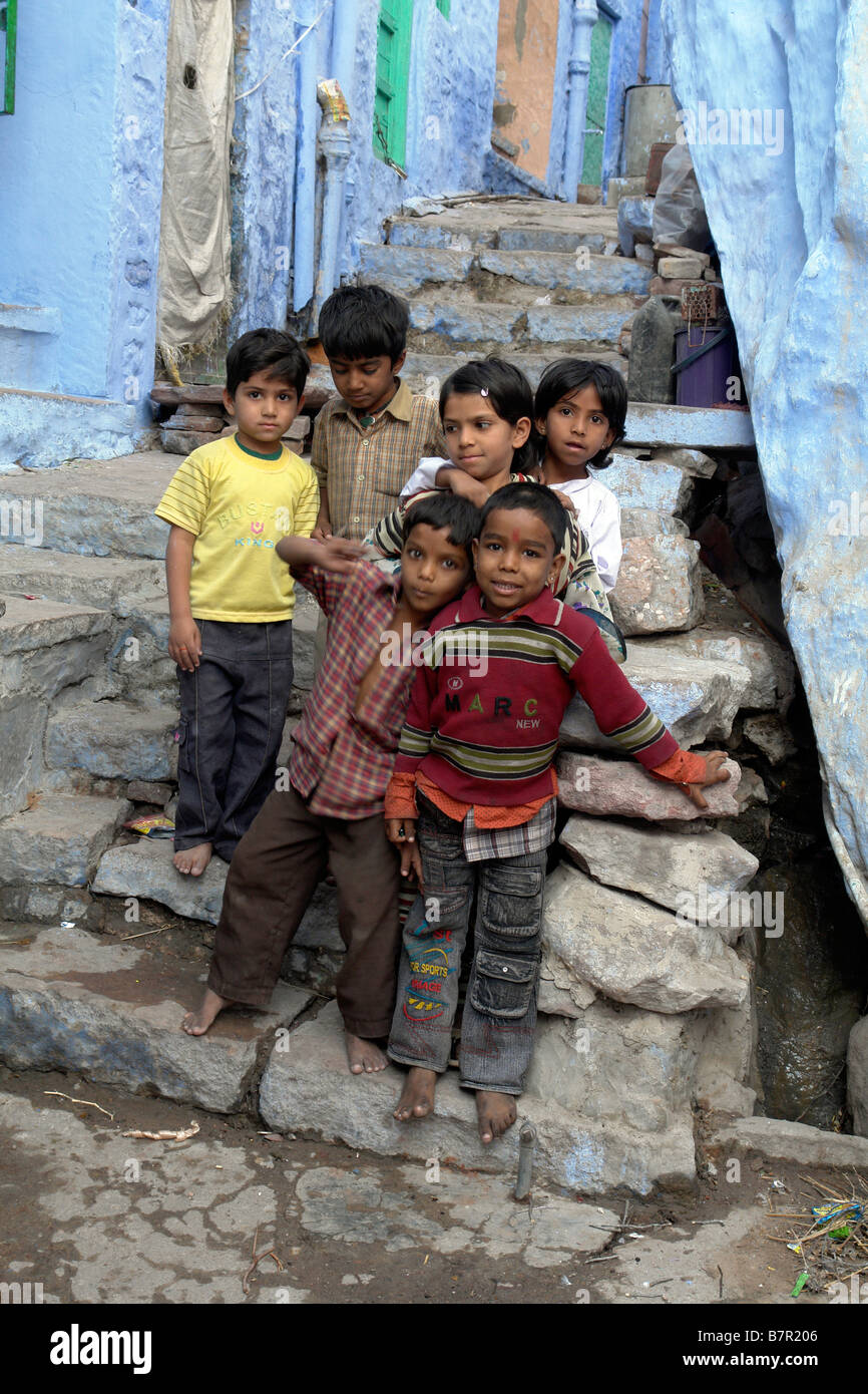 indian children in the back streets of the old city of jodhpur with traditional brahmin blue painted houses Stock Photo