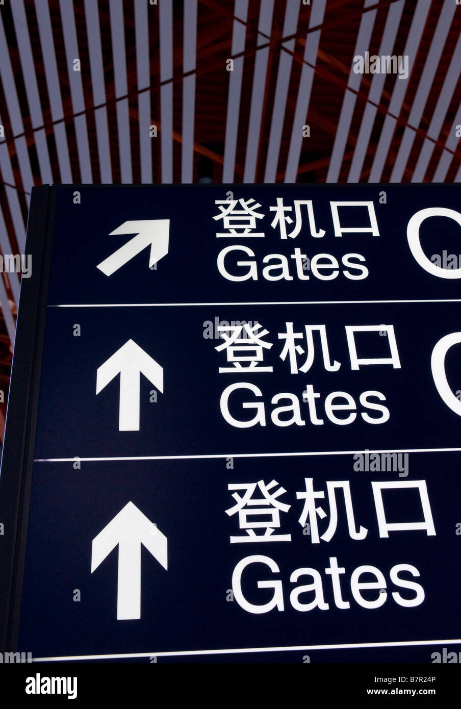 Airport information direction sign in China showing location to departure gates Stock Photo