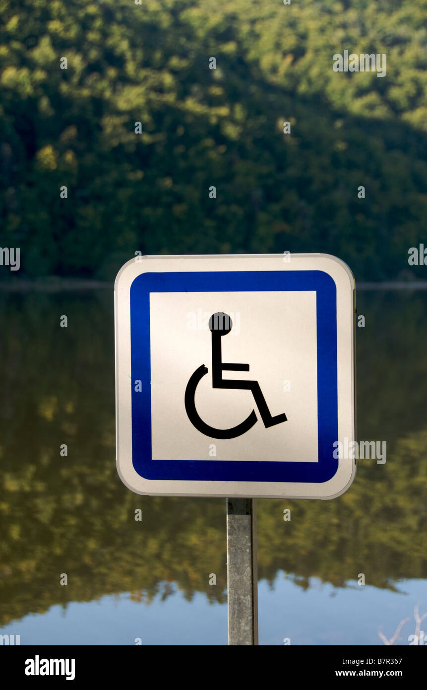 Disabled parking sign at the edge of a lake in the countryside Stock Photo