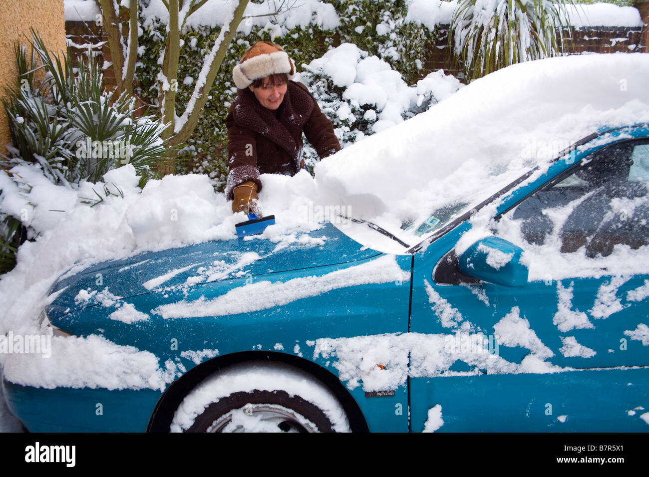 Scraping fresh snow from the car Stock Photo