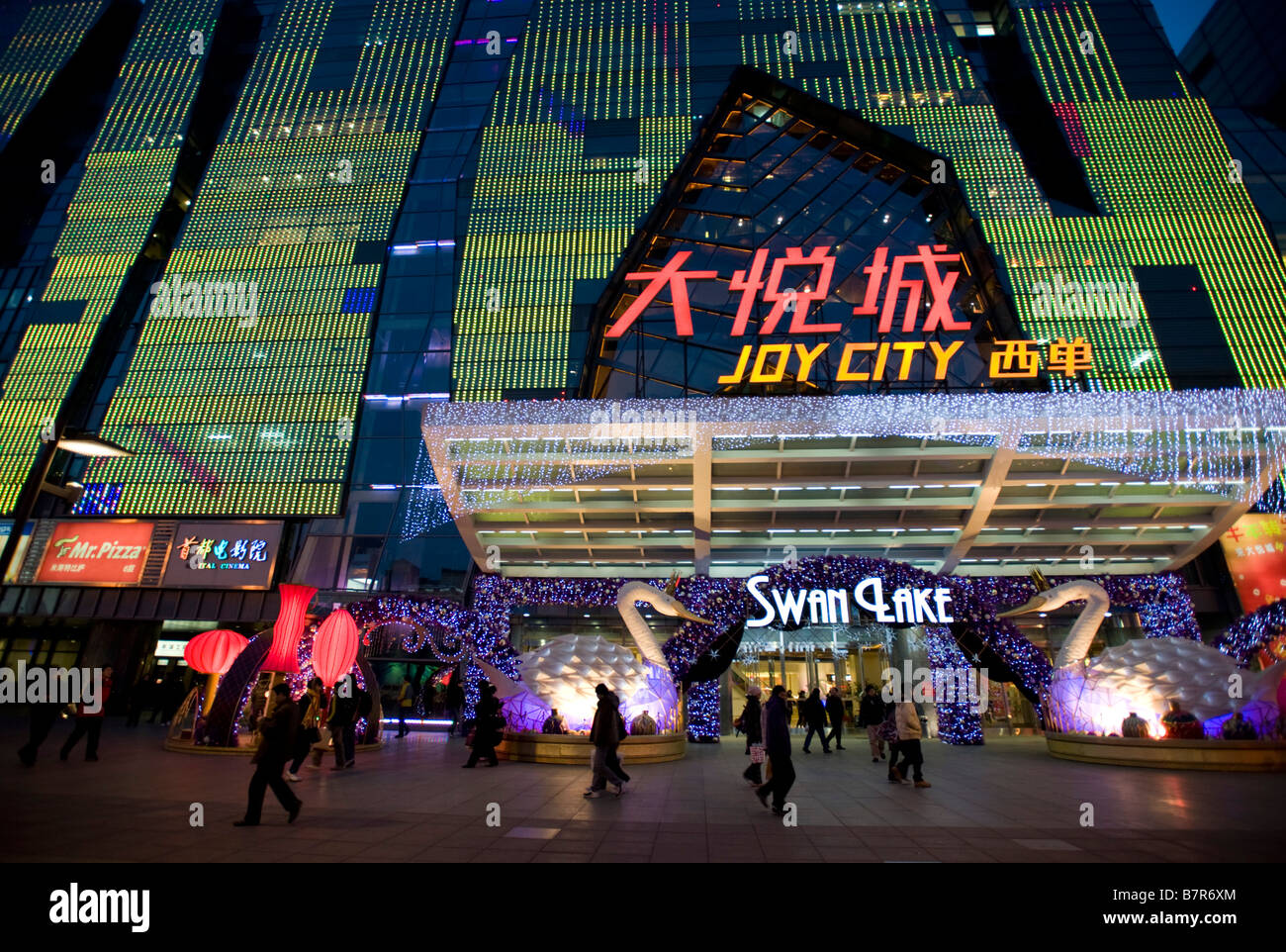 Dusk exterior view of large new modern shopping mall with spectacular lighting called Joy City in Xidan district Beijing 2009 Stock Photo