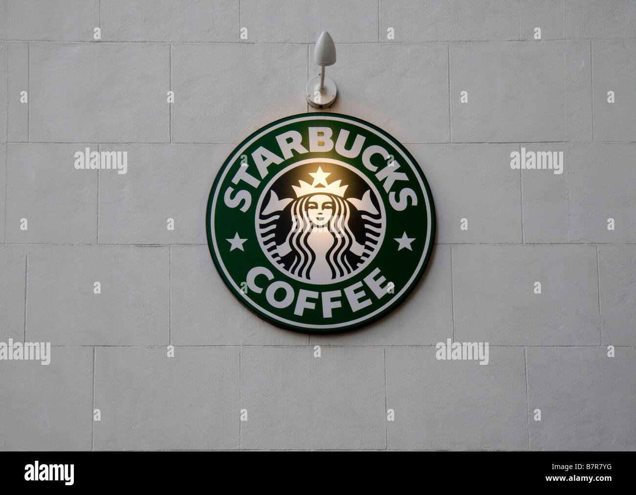 A Starbucks Coffee sign on the side wall of a branch in London's West End. Jan 2009 Stock Photo