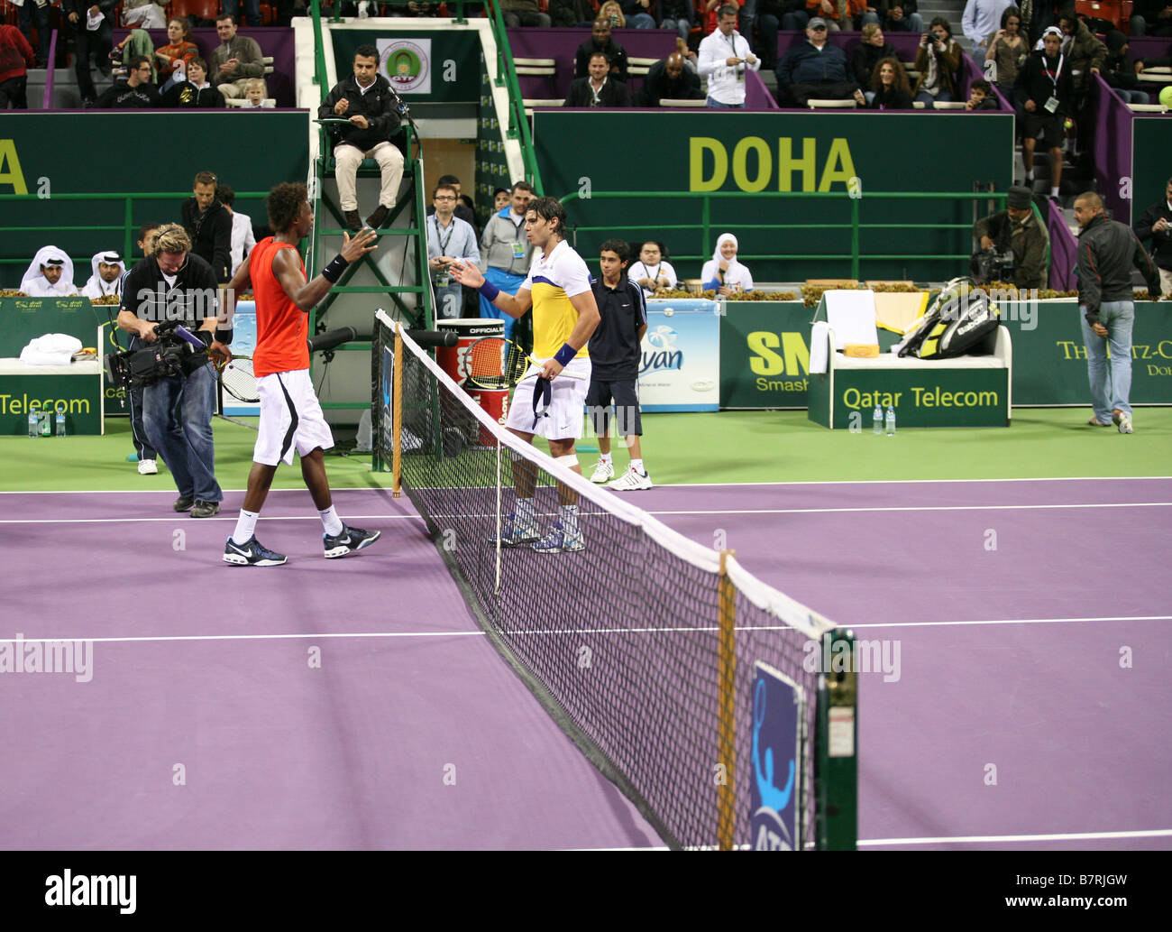 Gael Monfils and world No 1 Rafael Nadal shake hands at the net after Monfils inflicted won their match at the Qatar Open 2009 Stock Photo