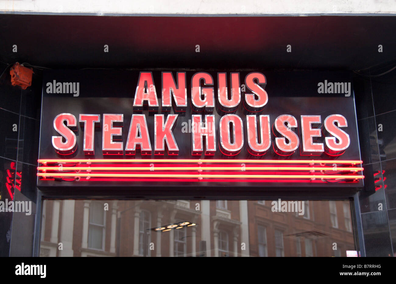 A shop sign above an Angus Steak Houses restaurant, Soho, London. Jan ...