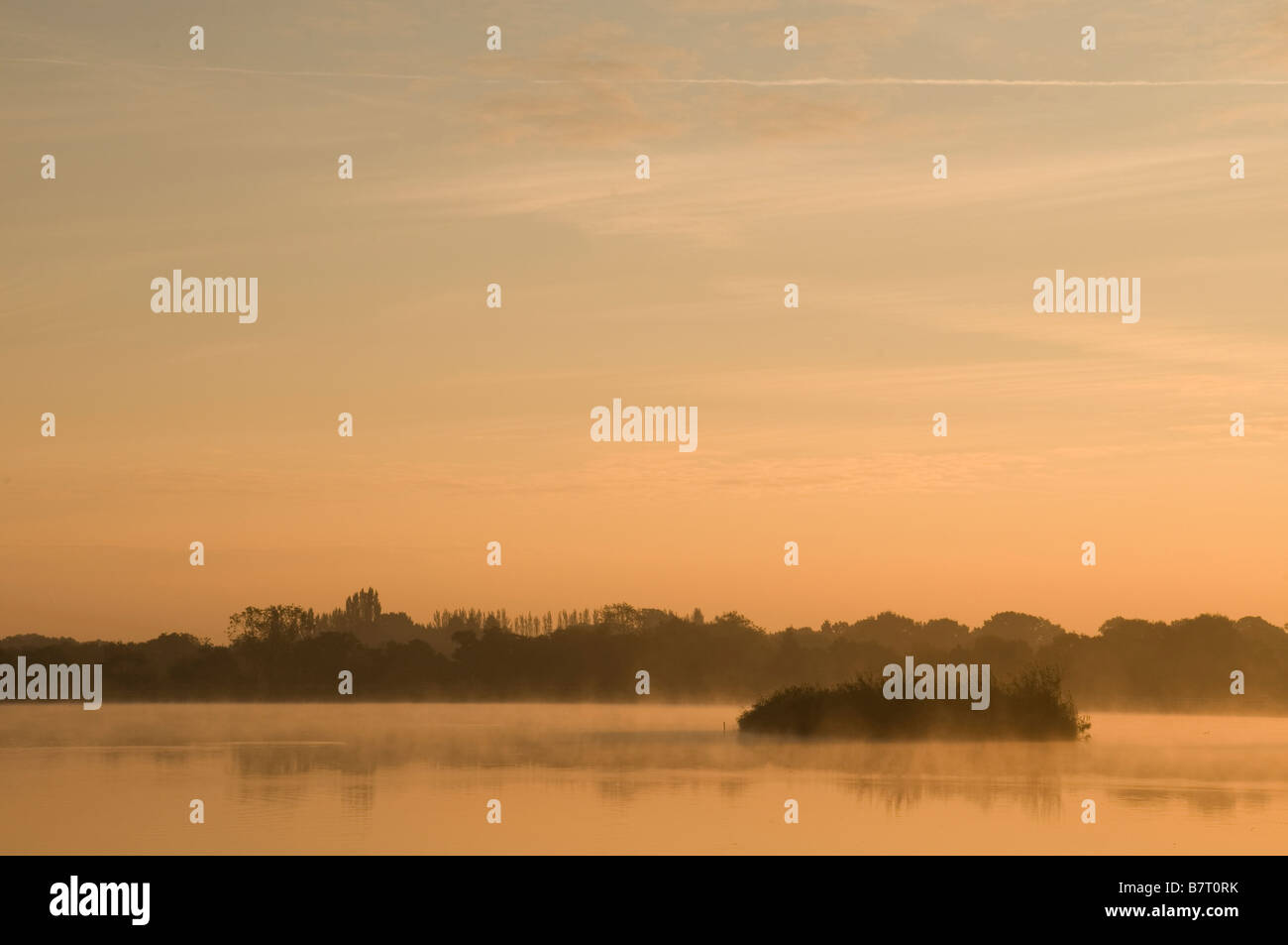 Late summer sunrise over the Engine Pool at Earlswood Lakes near Solihull in the West Midlands Stock Photo