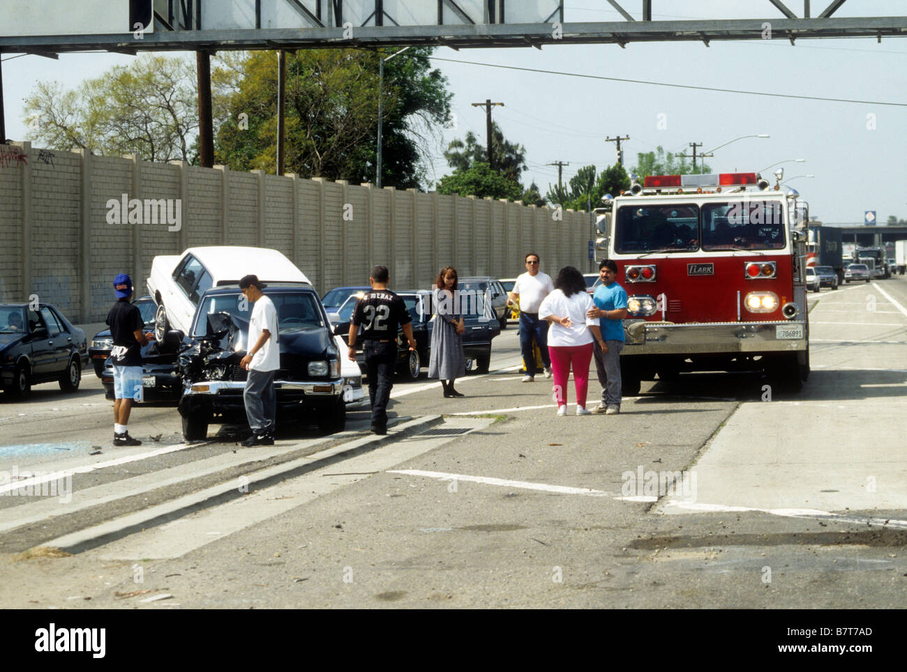 Firemen deal with auto crash on California freeway. Stock Photo